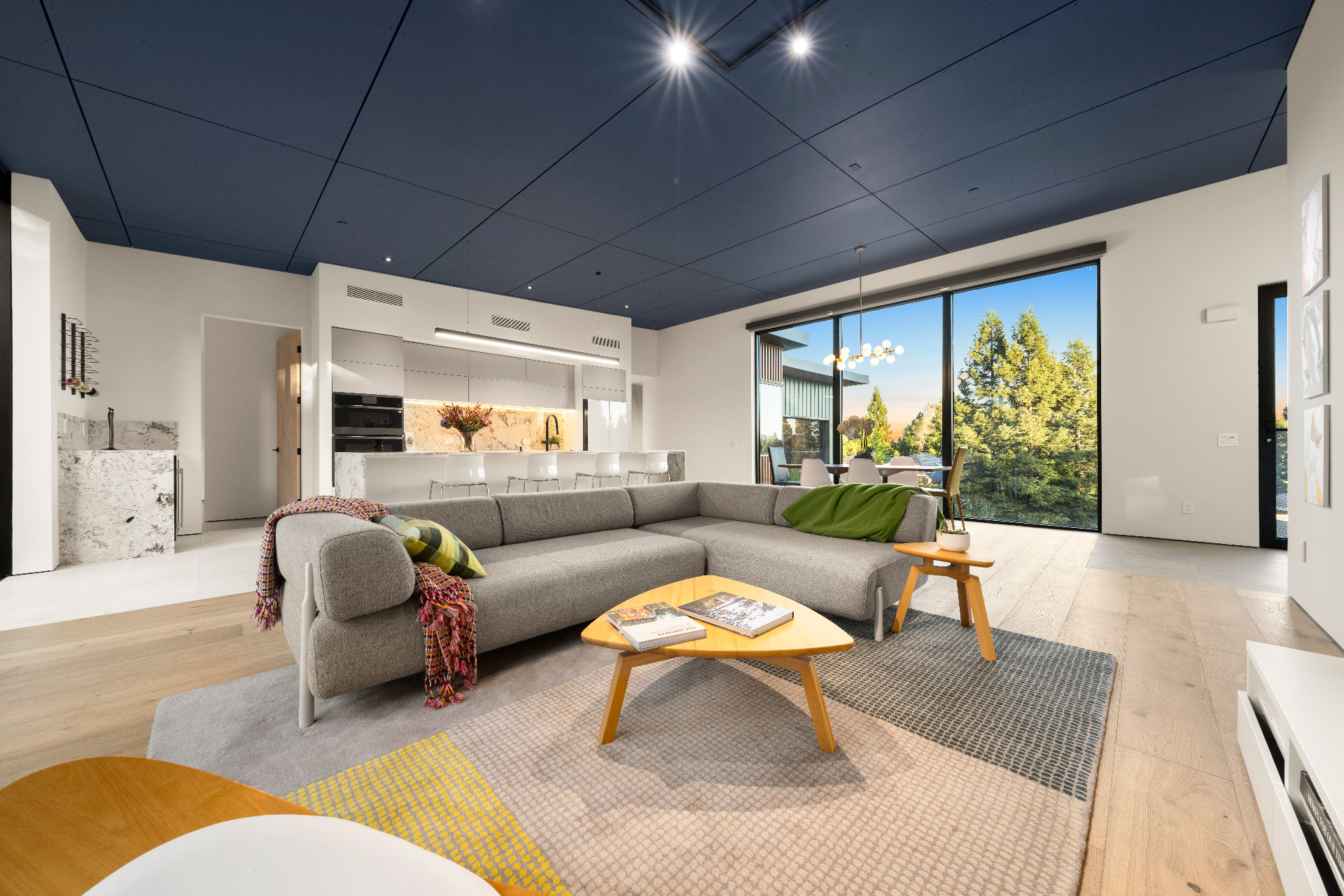 Living area with sectional and treetop views