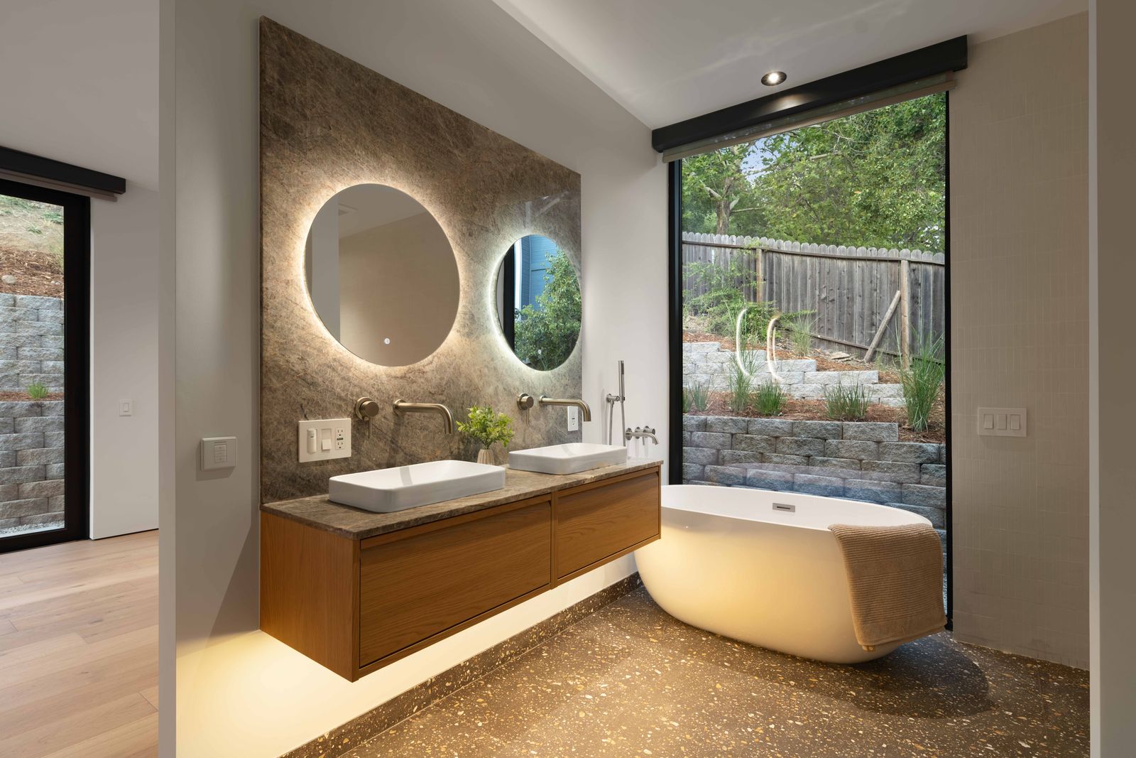 Primary bath with freestanding tub and stone vanity