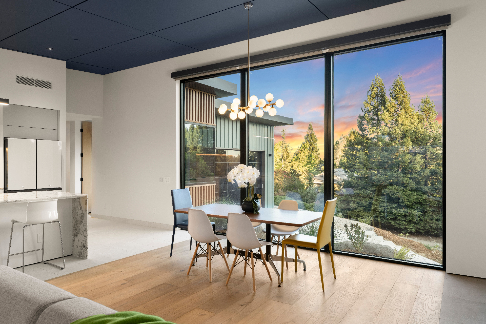 Dining area with floor-to-ceiling sunset views