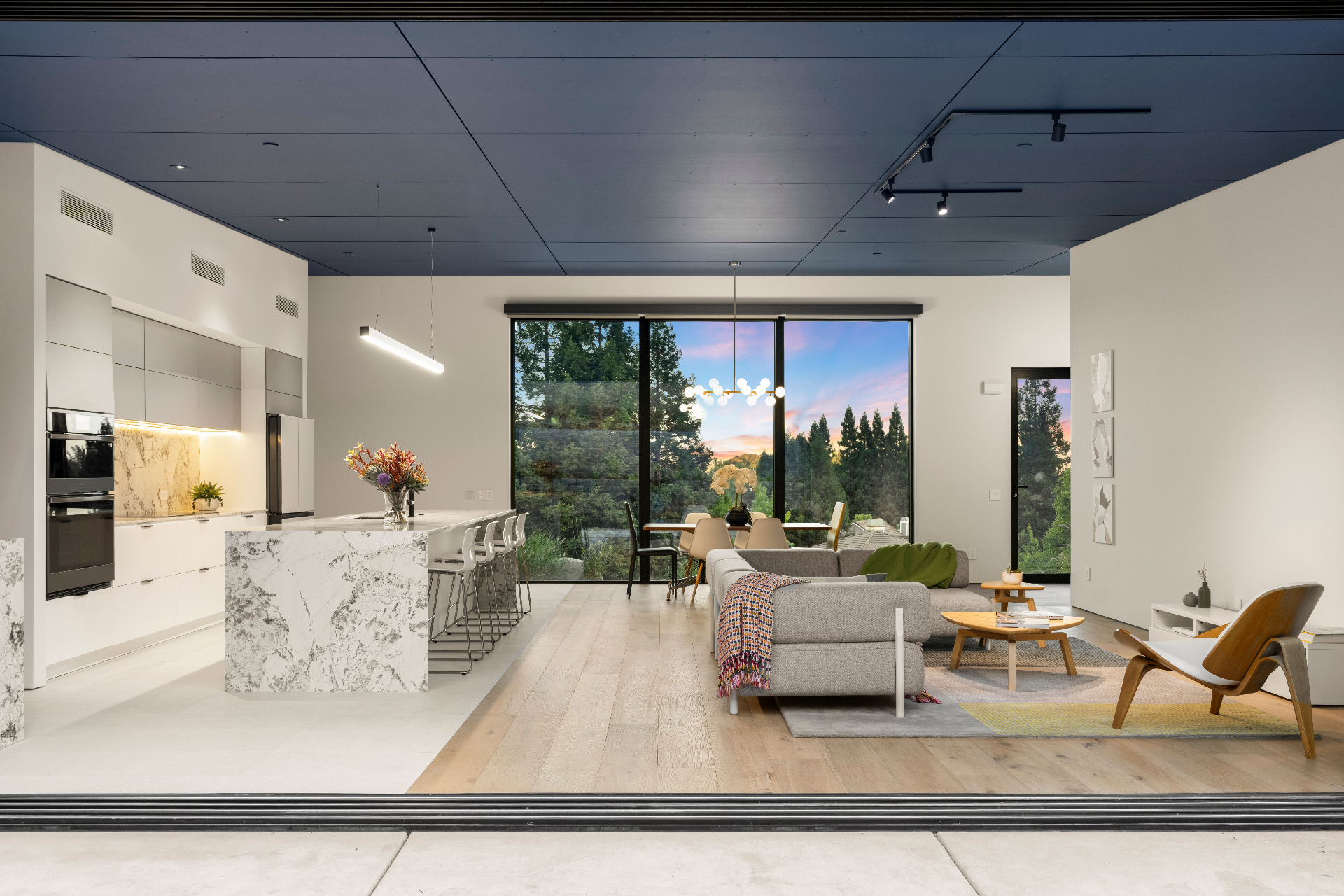 Great room, kitchen and dining at dusk