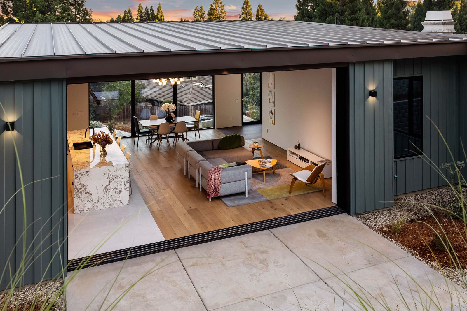 Rear patio with open sliding walls to the great room